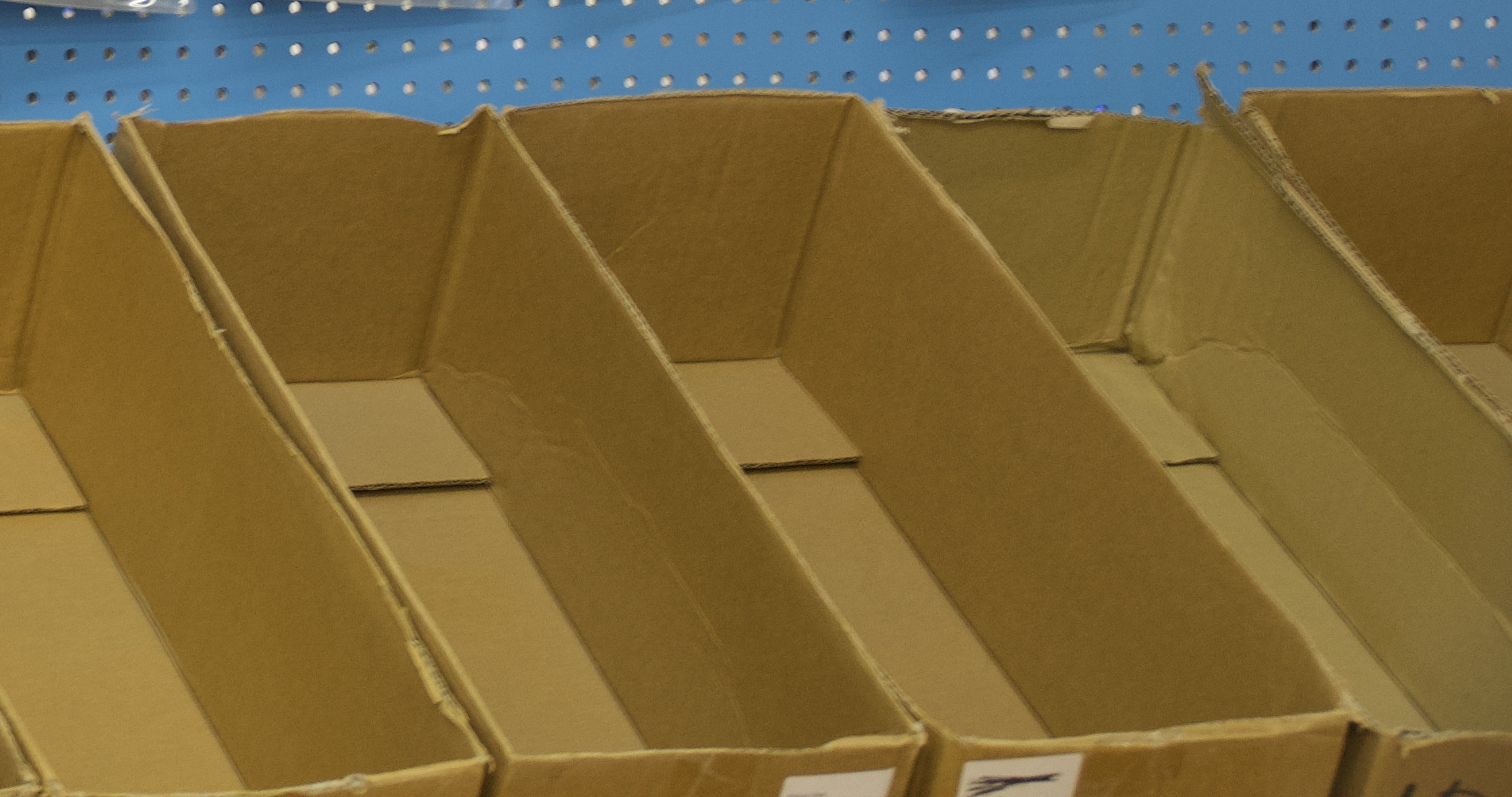 A series of open, empty cardboard boxes in a row