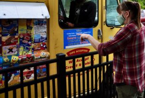 An eFulfillment Service team member is seen making a selection at the ice cream truck provided by Ben's Natural Health.