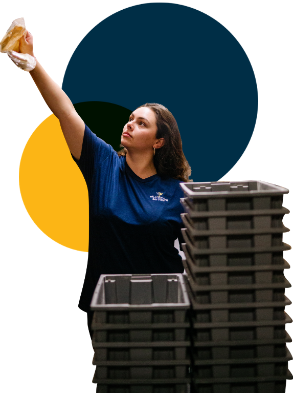 eFulfillment Service Female Employee Reaching up With Stacked Bins