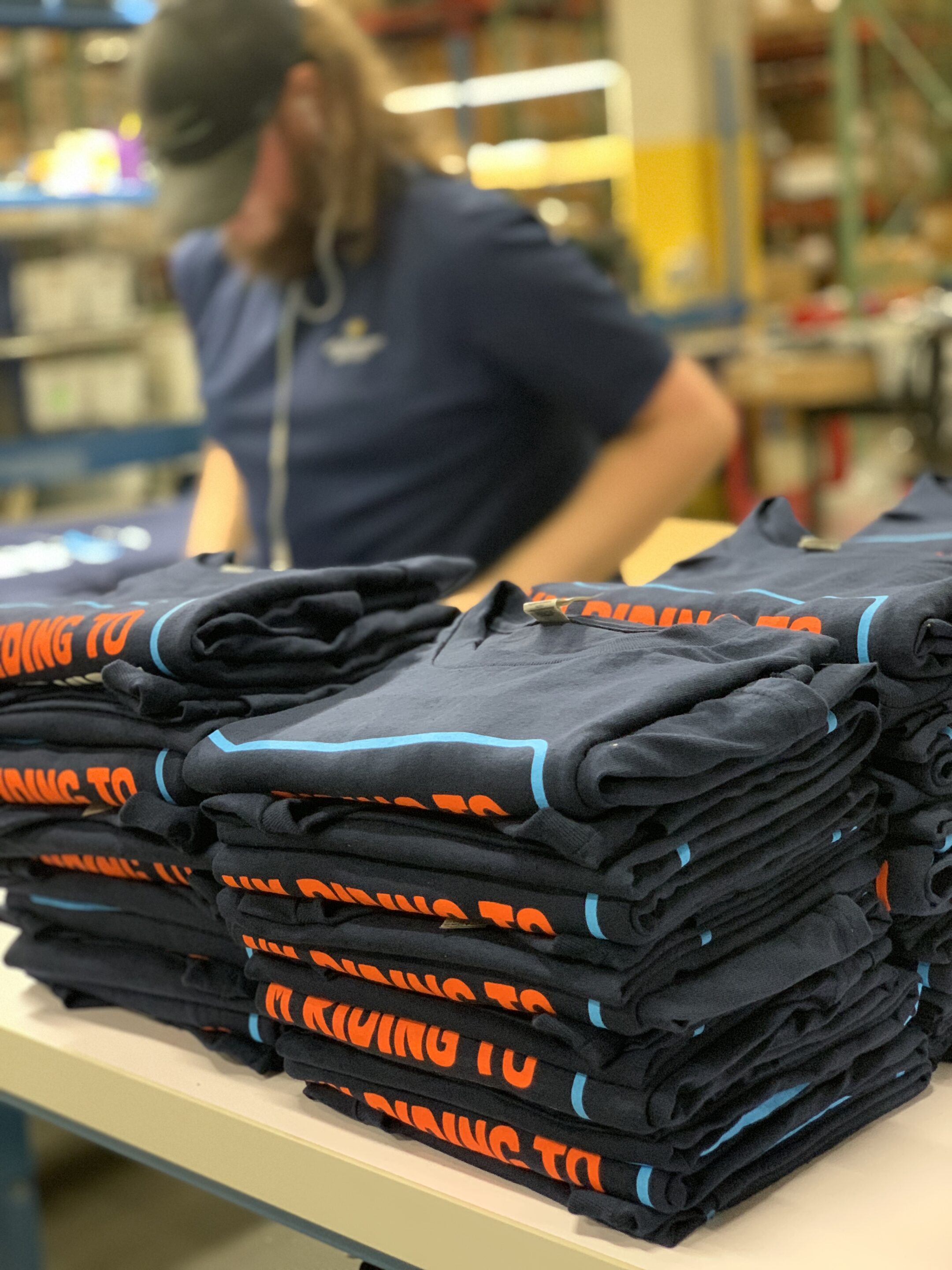 Professionally folded shirts being inventoried at an ecommerce fulfillment center