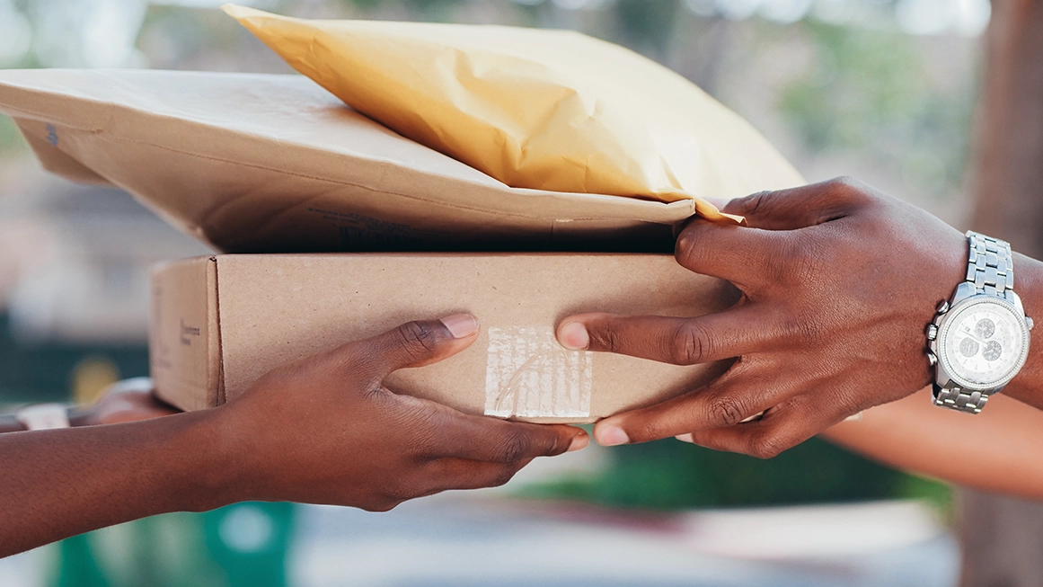 person handing over an Etsy package