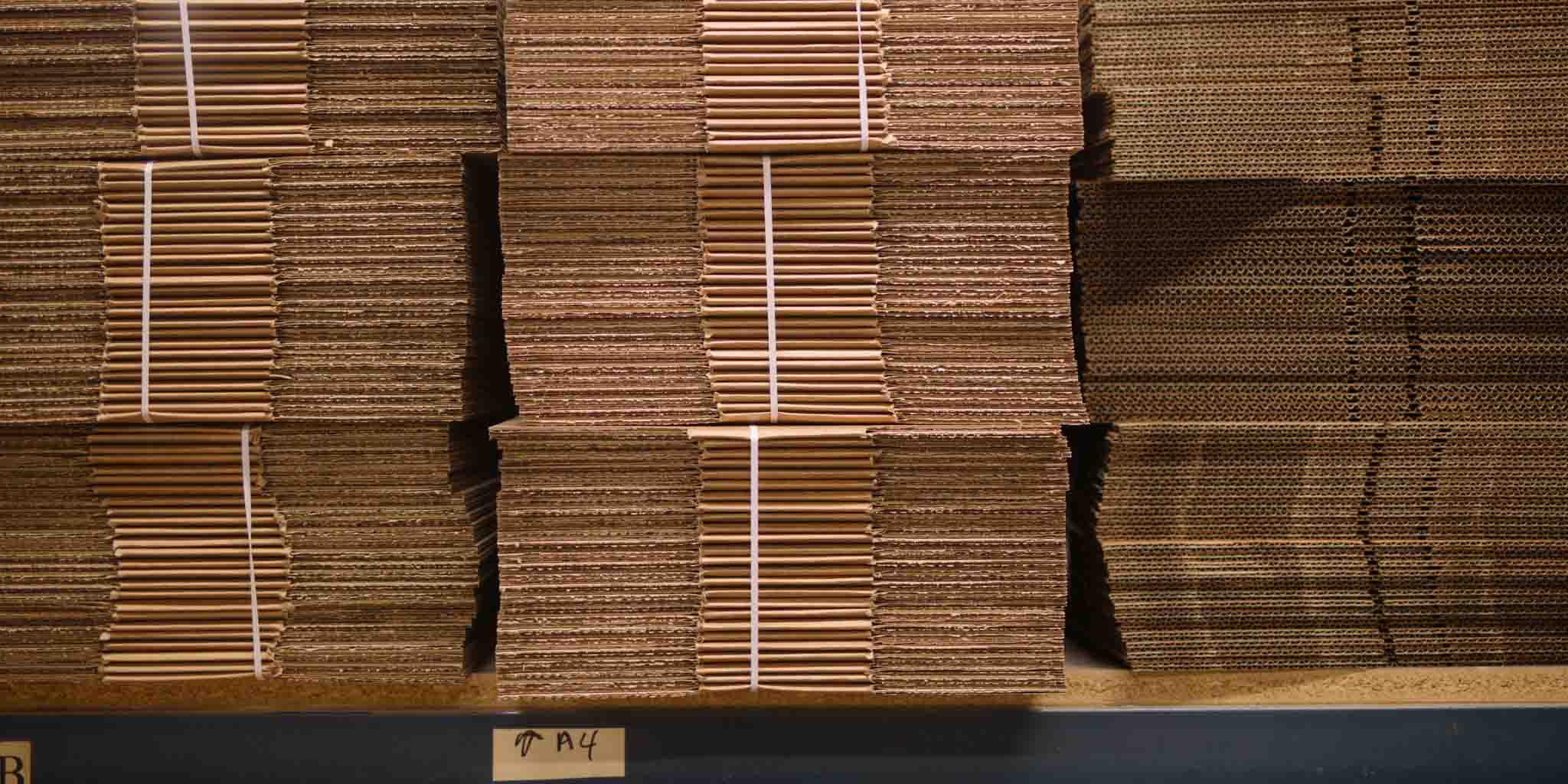 selecting a carton size stacked flat cardboard boxed
