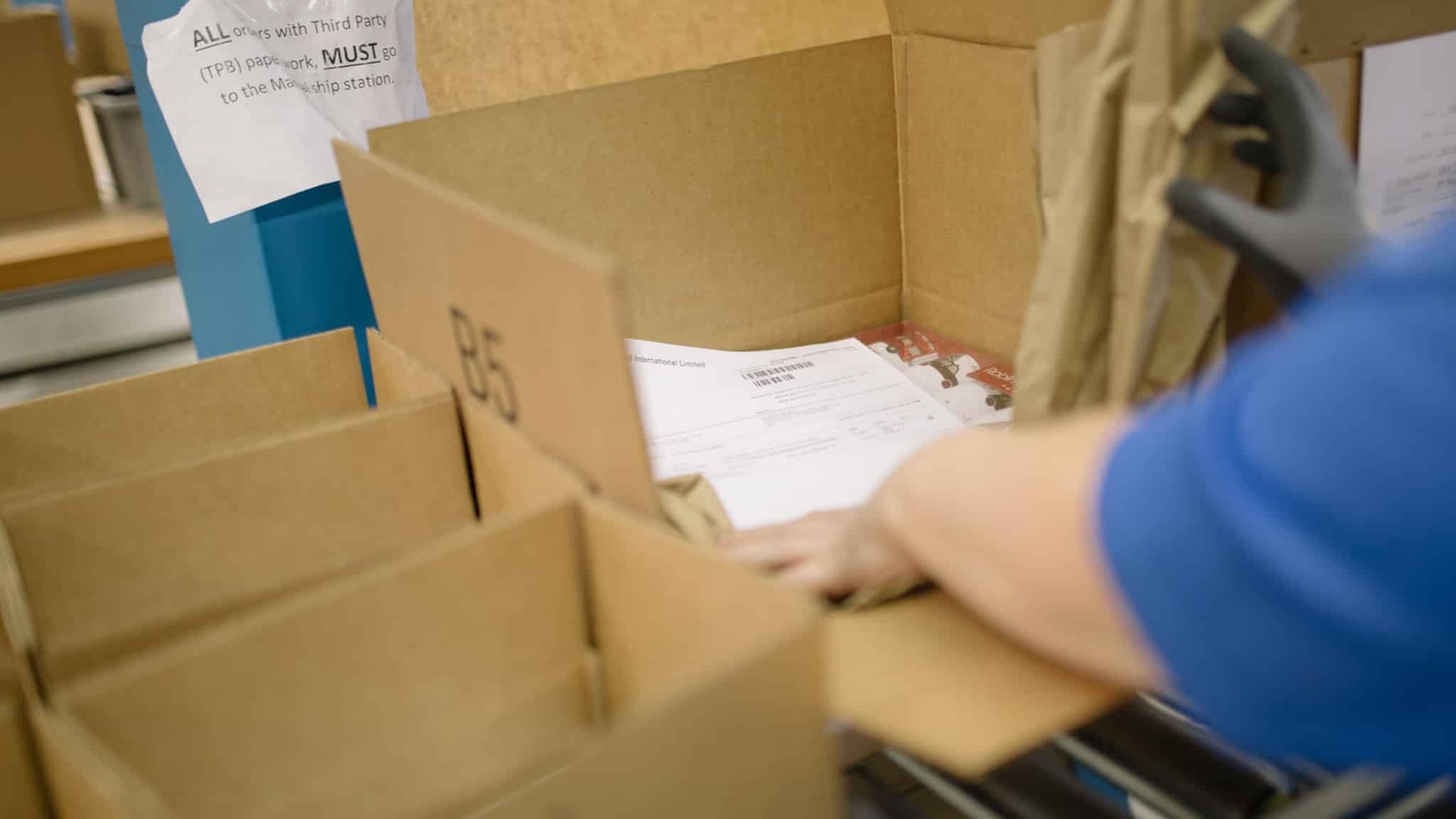 warehouse worker packing order into box