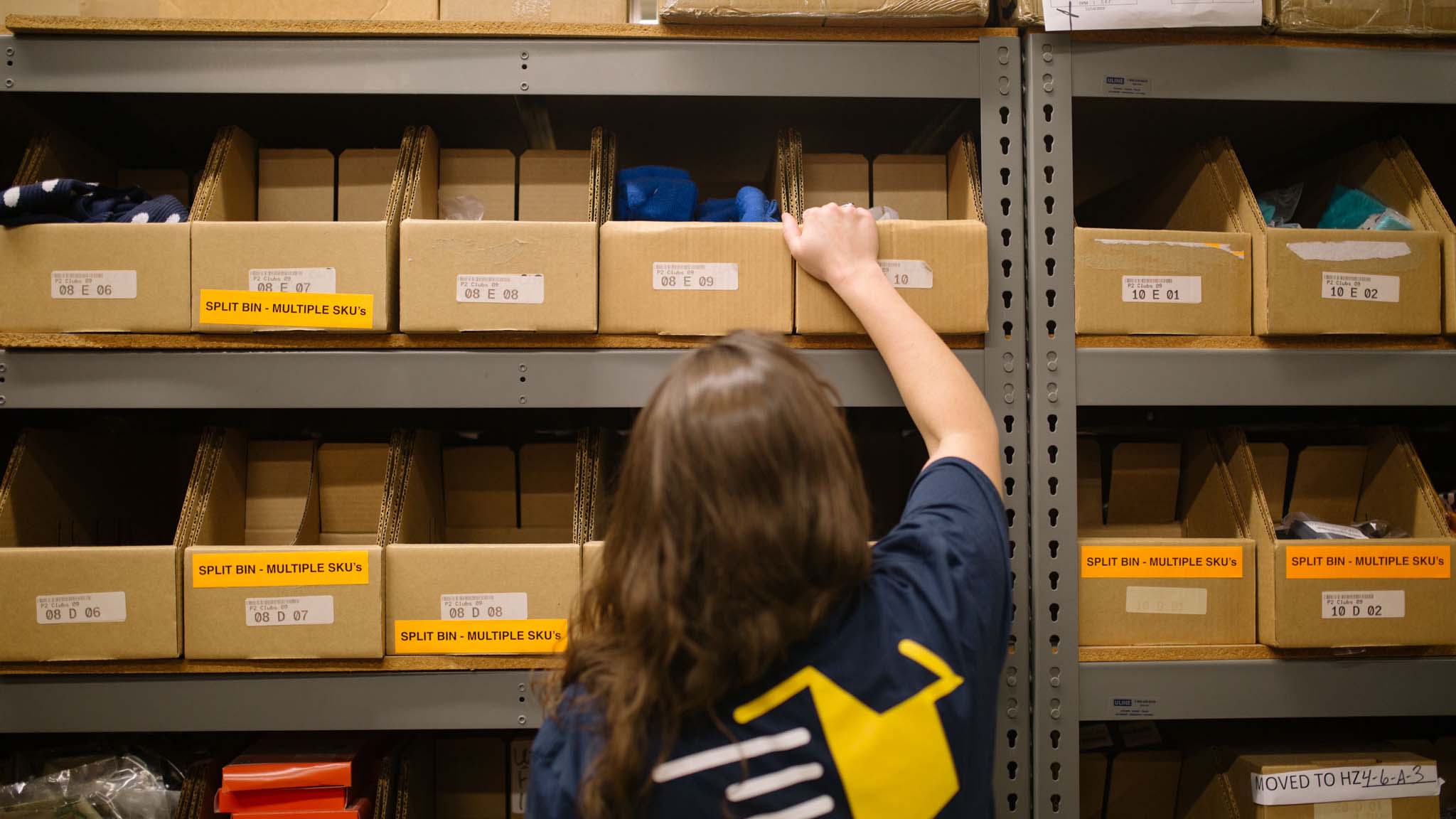 employee picking and packing item for shipment