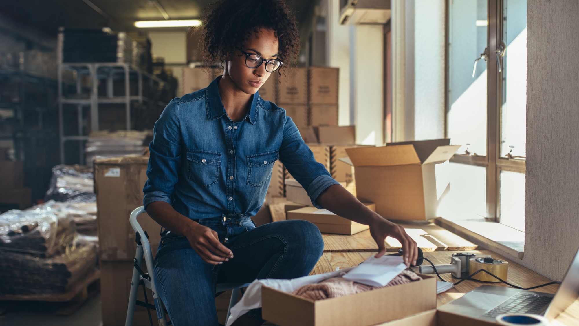 woman packaging an order to be fulfilled