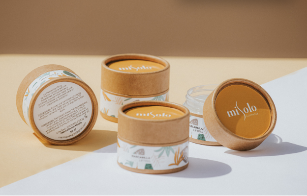 skincare photo of person labeling a box on a desk